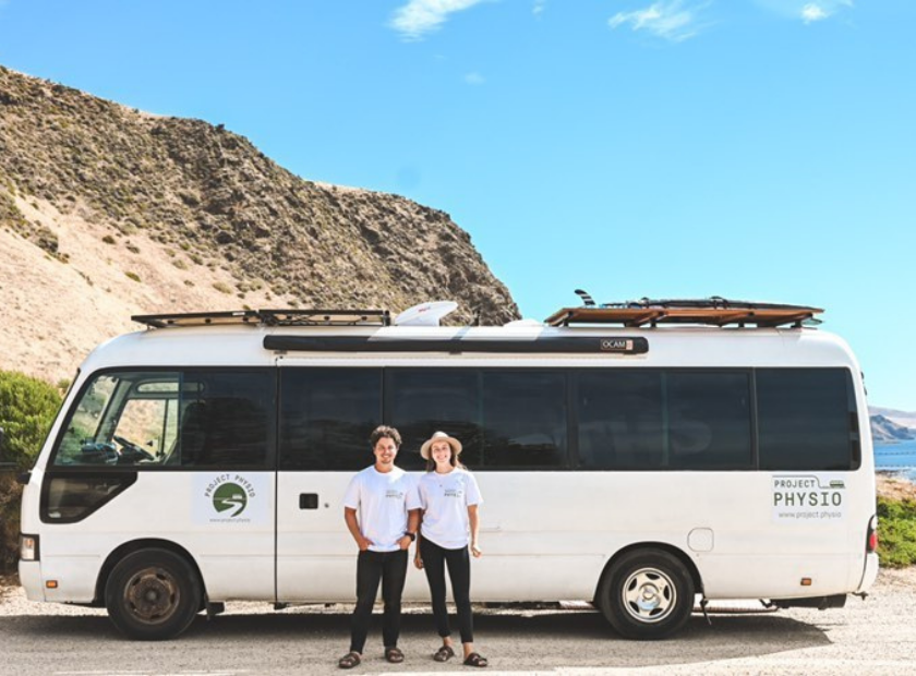 Project Physio team in front of their bus on the Australian coast